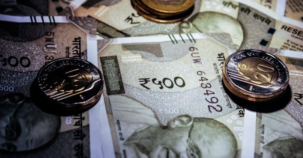 Detailed close-up of Indian currency notes and coins, featuring Mahatma Gandhi portrait.