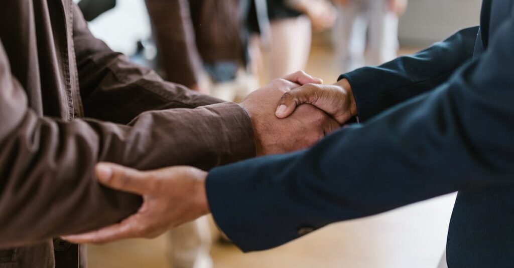 Close-up of two businesspeople shaking hands, symbolizing agreement and partnership.